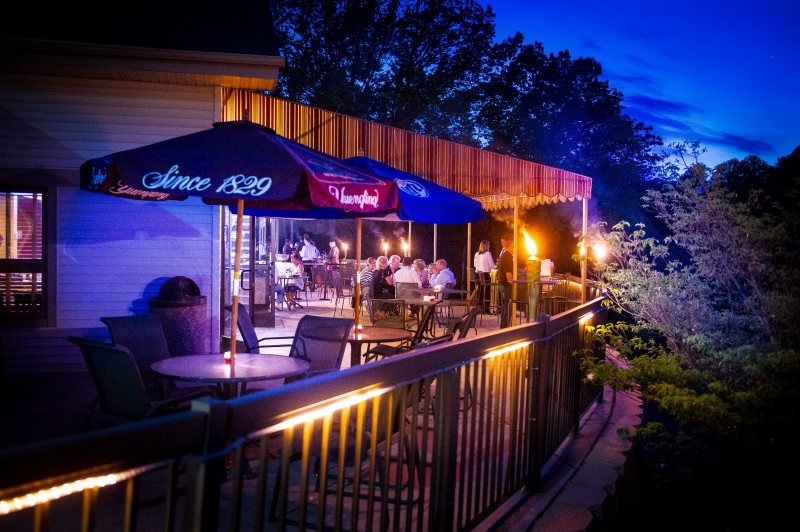 Patio deck glowing with string lights at dusk