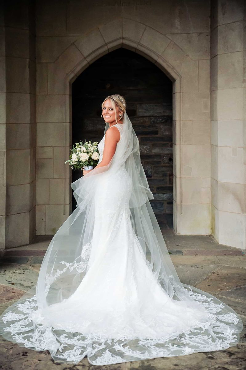 Bride beneath a stone archway