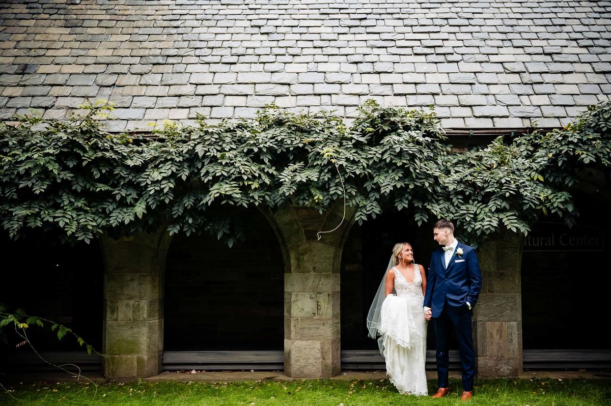 Couple beneath ivy-covered stone walls