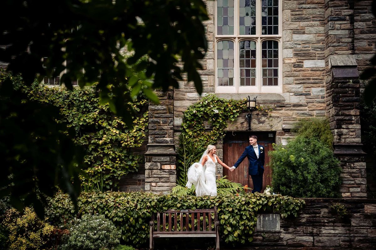 Couple in a garden beside a stone building