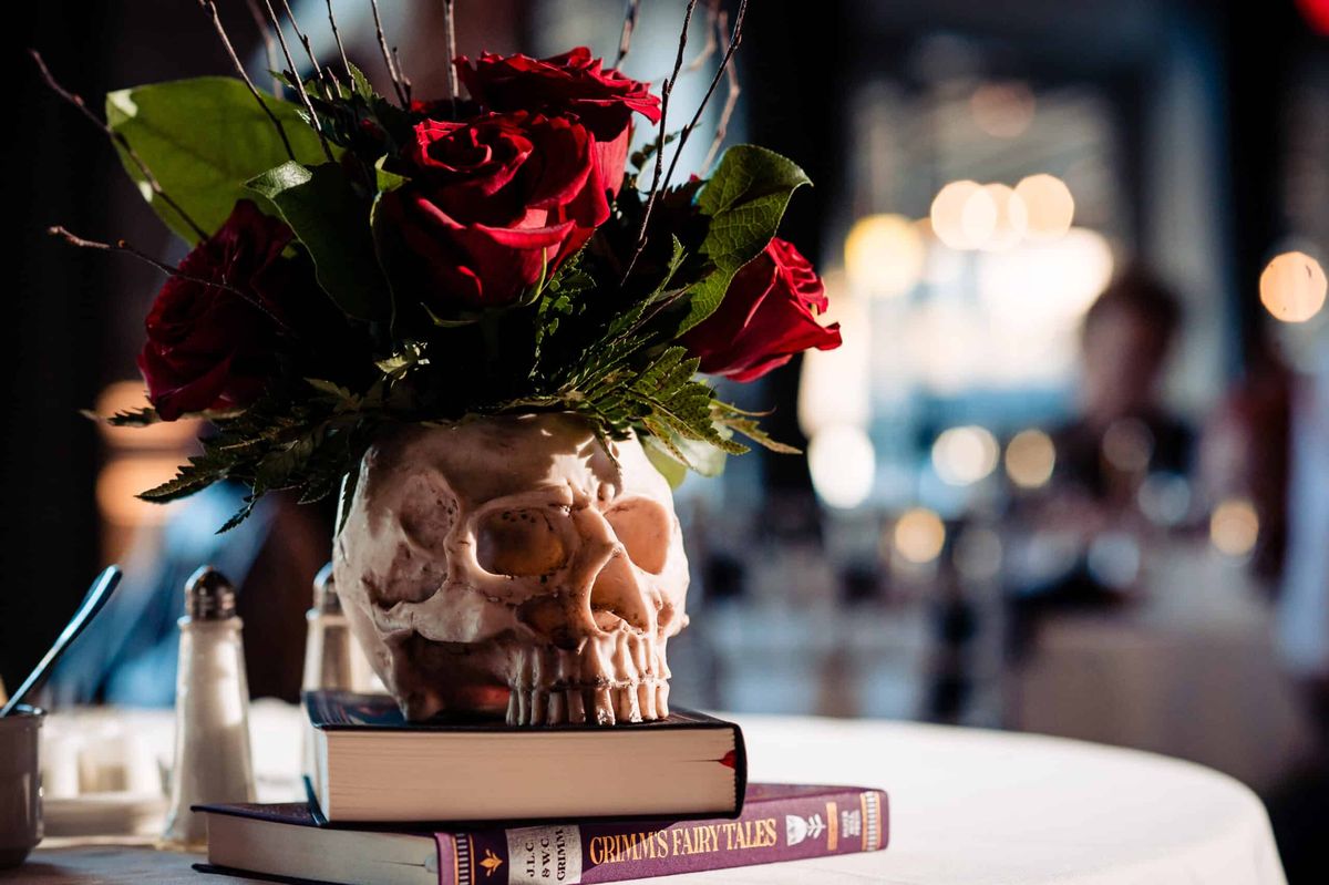 Red roses in a skull vase centerpiece