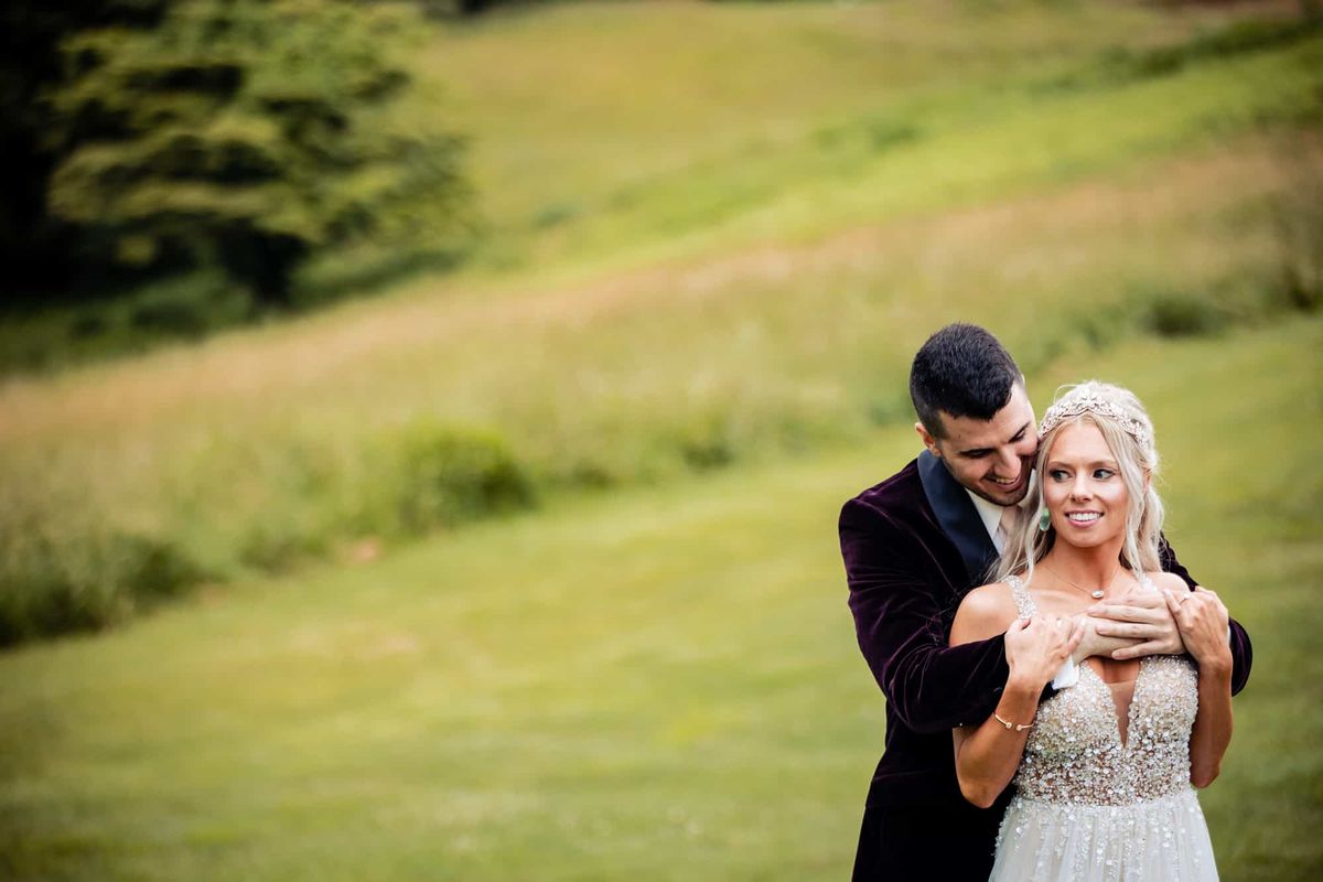 Groom embracing the bride on the course