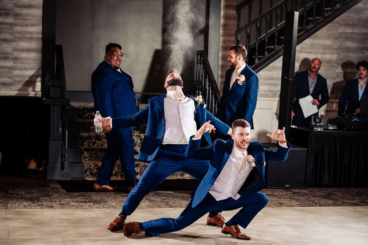 Groomsmen dancing during the grand entrance