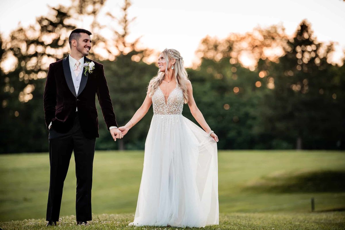 Couple walking hand in hand at sunset