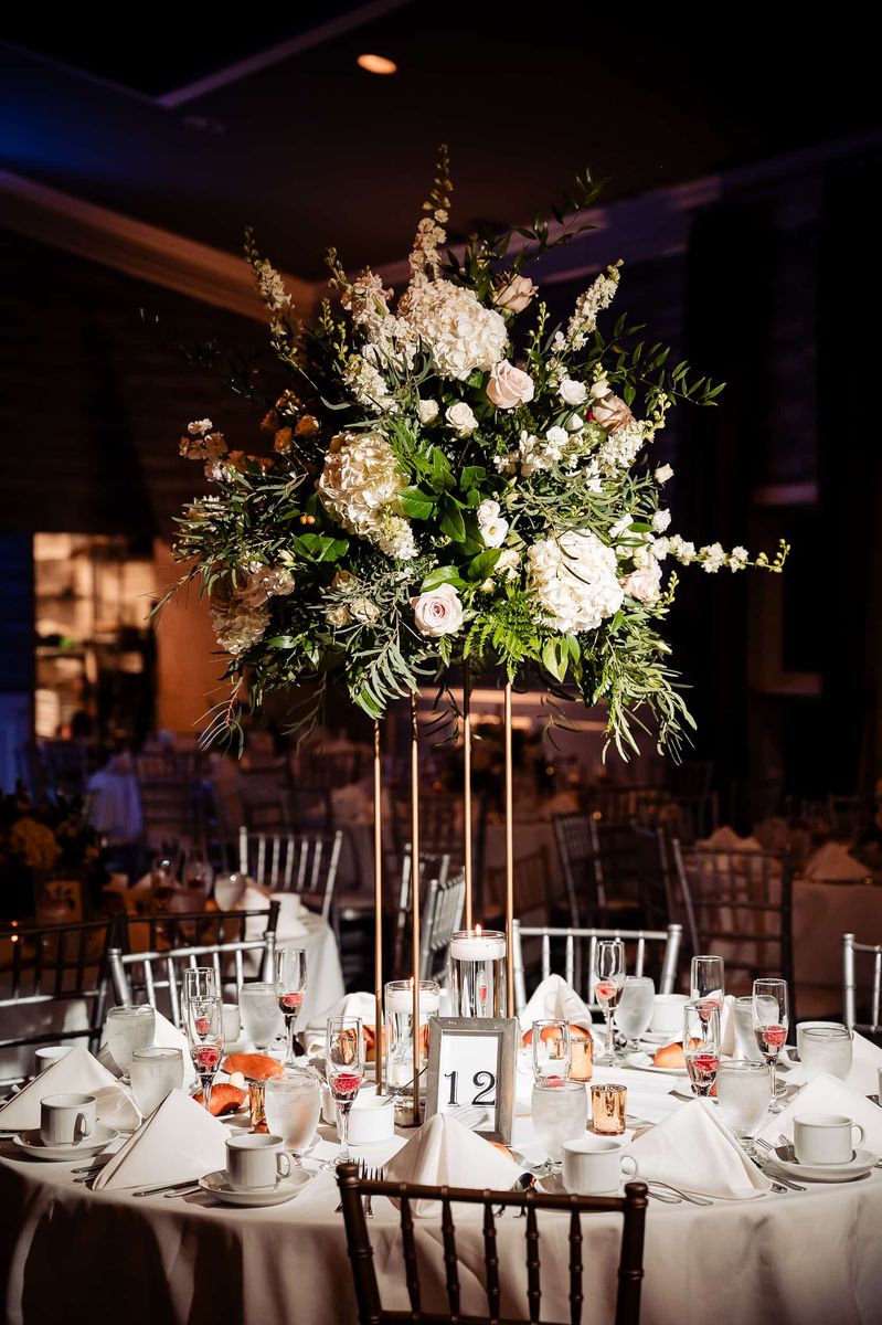 Tall floral centerpiece on a reception table